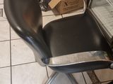 a chair that is sitting in front of a refrigerator