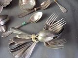 a lot of silver spoons and spoon spoons on a table