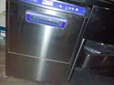 stainless steel dishwasher sitting on top of a counter next to a trash can