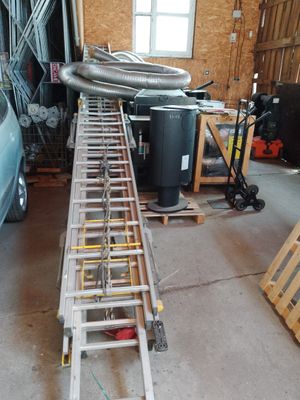 a ladder that is sitting in a garage next to a car