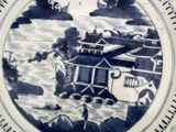 a blue and white plate with a picture of a boat in the water
