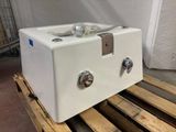a white machine that is sitting on a pallet