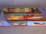 a red and yellow toy plane in a box on a table