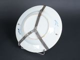 a white plate with a ribbon on it on a table