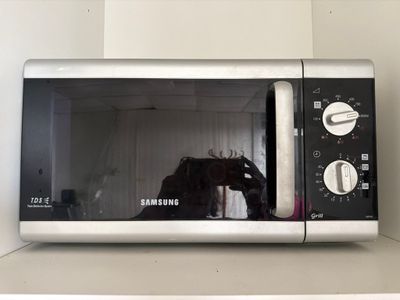 a microwave that has a horse in it on top of a shelf