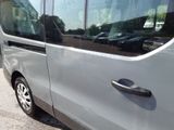 a silver van that is parked in a parking lot