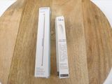 a box of aloe on a wooden table next to a tube of aloe
