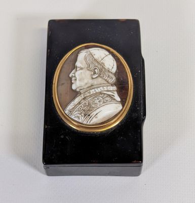 a picture of a black and gold box with a picture of a man