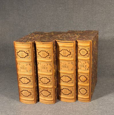 three books are stacked on top of each other on a gray surface