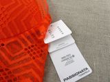 a close up of an orange dress with a tag attached to it