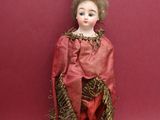 an image of a doll with a wooden stick on a red background
