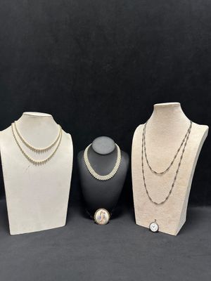 three different types of necklaces on display on a black background