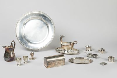 several silver objects are arranged on a white surface
