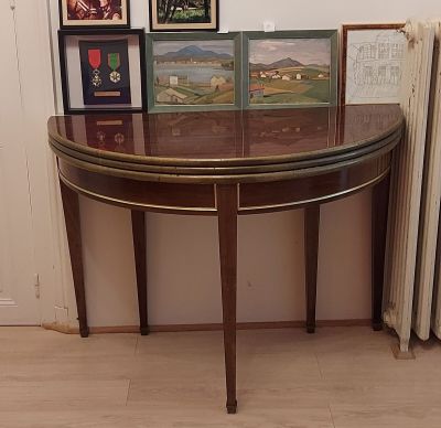 a table with pictures on it and a radiator in the corner