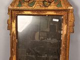 a mirror that is sitting on a stand on the floor