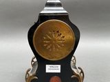 an image of a clock on a stand with a bird on top