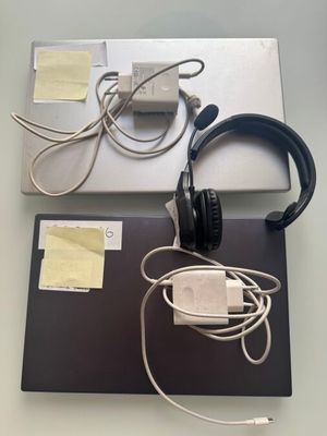 two laptops and headphones on a table