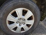 a tire on the side of a car with a flat tire