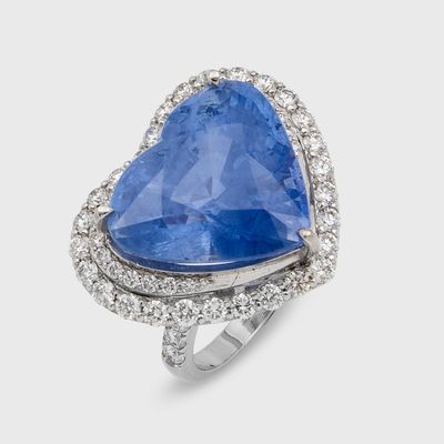 a close up of a blue sapphire and diamond ring on a white background