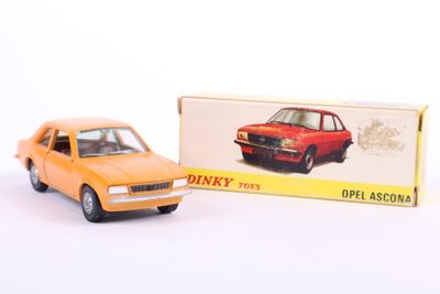 a toy car that is sitting next to a box