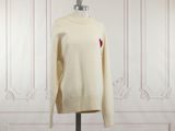 le pull, orné d'un cœur, est présenté sur un mannequin
