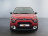 the front view of a red citrole parked in a white room