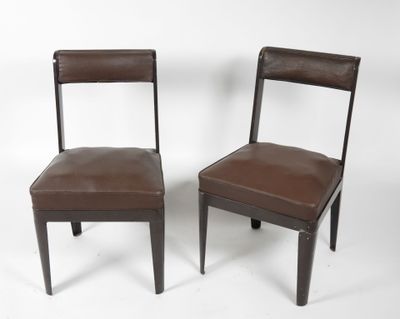 pair of brown leather dining chairs on a white background