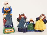 three figurines of people that are standing next to each other