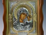 an icon of the mother and child in a wooden frame