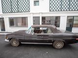 a black car parked in front of a building