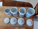 six cups sitting on a wooden table next to each other