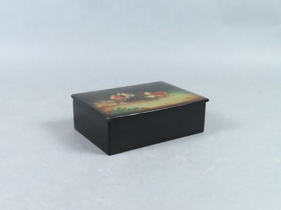 a small black box with a painting on it