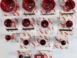 a lot of red wine glasses on a white table