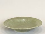 green bowl on a white table with a white background