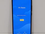 a close up of a cell phone on a table with a blue screen