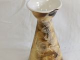 a small vase that is sitting on a white surface