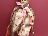 a doll that is sitting on top of a stick