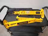 two heavy duty jacks sitting on top of a black chair
