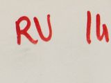 a red writing on a white wall that says rum