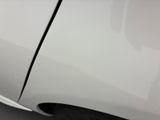 a close up of a white car with a broken door handle