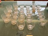 a lot of empty wine glasses on a glass table