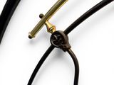 a close up of a black and gold clock on a white background