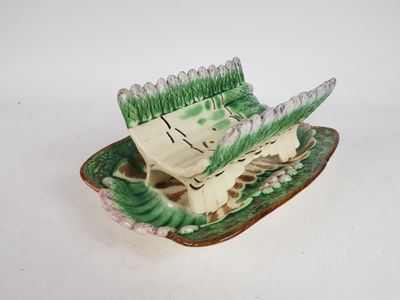 a small green and white plate with a bird on it