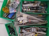 a lot of newspapers in the green bins on the floor
