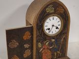 a clock that is sitting on a table with a book