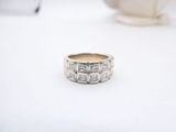 a close up of a ring on a table with a cup of coffee in the background