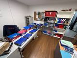 a desk with a lot of books on it in a room