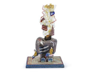 a figurine of a man sitting on a chair