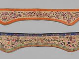 two pieces of cloth with designs on them hanging on a wall
