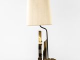 a close up of a lamp on a table with a lamp shade on it